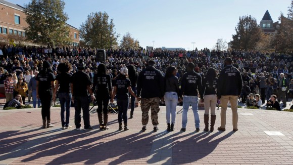 Members of black student protest group Concerned Student 1950 hold hands following the announcement that University of Missouri System President Tim Wolfe would resign Monday, Nov. 9, 2015, at the university in Columbia, Mo. Wolfe resigned Monday with the football team and others on campus in open revolt over his handling of racial tensions at the school. (AP Photo/Jeff Roberson)