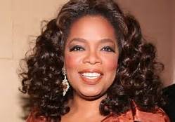 Oprah... Wearing white women curls. Shame 